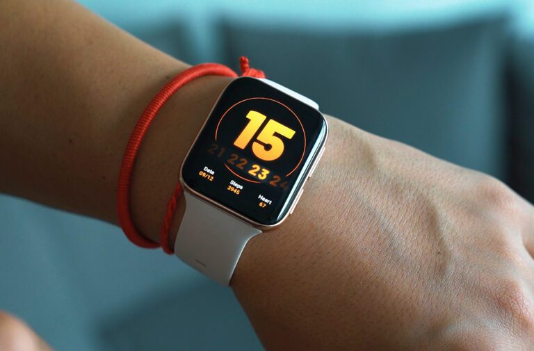 Smartwatch displaying time on a person's wrist.