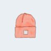Pink beanie hat with white patch.