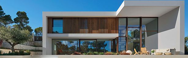 Modern house with large glass windows.