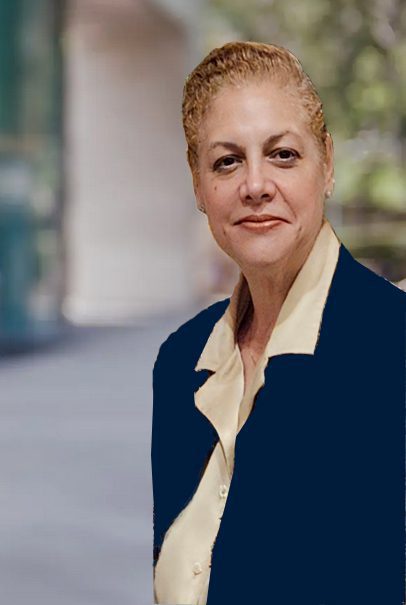 Person standing outdoors in business attire.