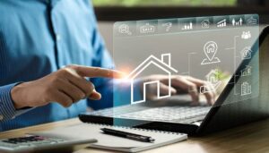 Person using laptop with virtual real estate icons.